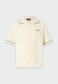 Short-sleeved cream button-up shirt with black piping along the collar and sleeves, featuring a chest pocket with embroidered logo.