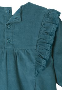 Tealfarbige Cord-Pullover mit einem geknöpften Kragen, gerafftem Spitzenbesatz auf einer Seite und vertikal geripptem Muster.