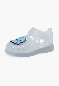 Clear jelly sandal with a blue octopus-shaped detail. Features open design, adjustable strap, and a patterned insole. Translucent material.