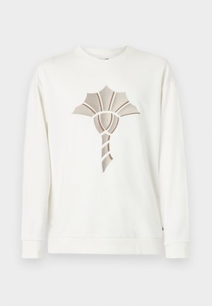 Weißer Pullover mit einem strukturierten, stilisierten beigen Blumendesign in der Mitte. Mit rundem Halsausschnitt und gerippten Bündchen.