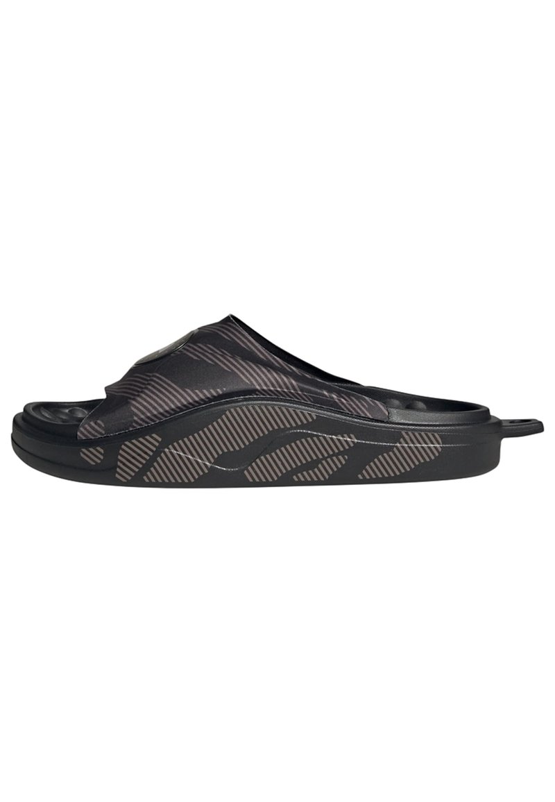 Black slide sandal with a textured, patterned upper and a thick sole. Features a smooth finish and a slight curve in the design.