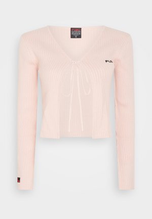Light pink knitted cropped top with long sleeves, V-neck, and drawstring tie. Features ribbed texture and subtle branding on the chest.