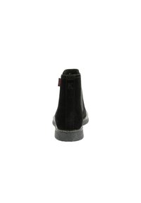 Black suede ankle boots with a textured sole, featuring a small red tag and a logo on the back, designed for a snug fit.