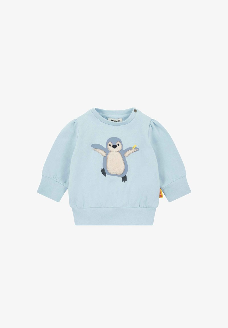 Sudadera azzurra con applique di pinguino e accessorio giallo, maniche arricciate e orlo a costine. Due bottoni a pressione sulla spalla.