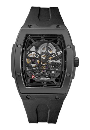 Montre squelette noire avec un boîtier rectangulaire et un bracelet en caoutchouc. Mécanismes intérieurs visibles avec des accents argentés et violets. Marqueur triangulaire notable.
