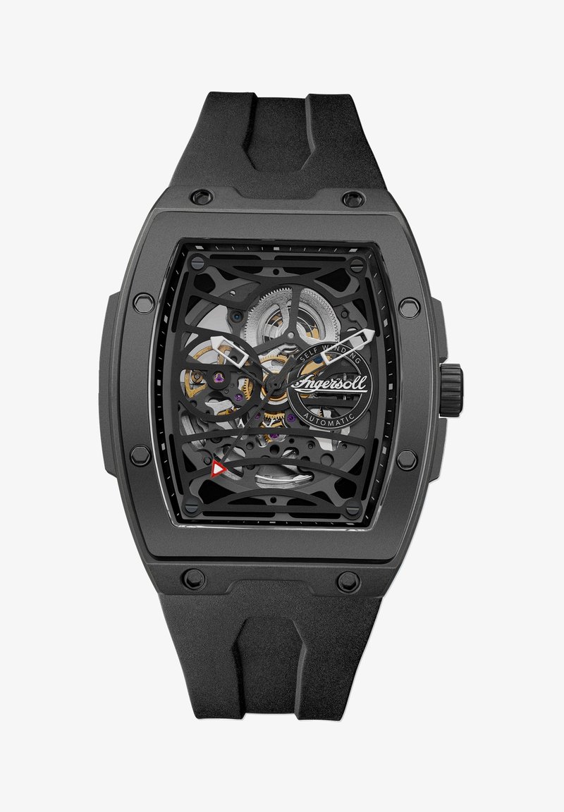 Zwarte skeletwatch met een rechthoekige kast en rubberen band. Zichtbare binnenmechanica met zilveren en paarse accenten. Opvallende driehoekige markering.