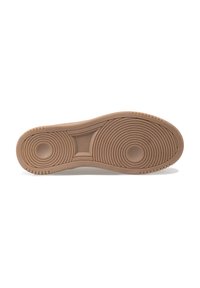 Sole of a shoe, featuring a tan color with concentric circular patterns, textured grip areas, and a smooth central section.