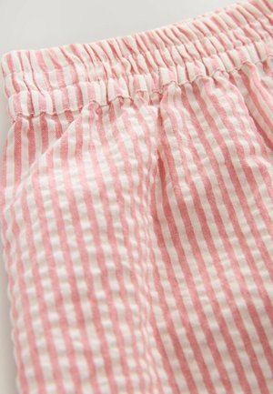 Tessuto a strisce rosa e bianche con una vita elasticizzata, caratterizzato da una trama morbida e linee verticali. Visione ravvicinata del materiale.