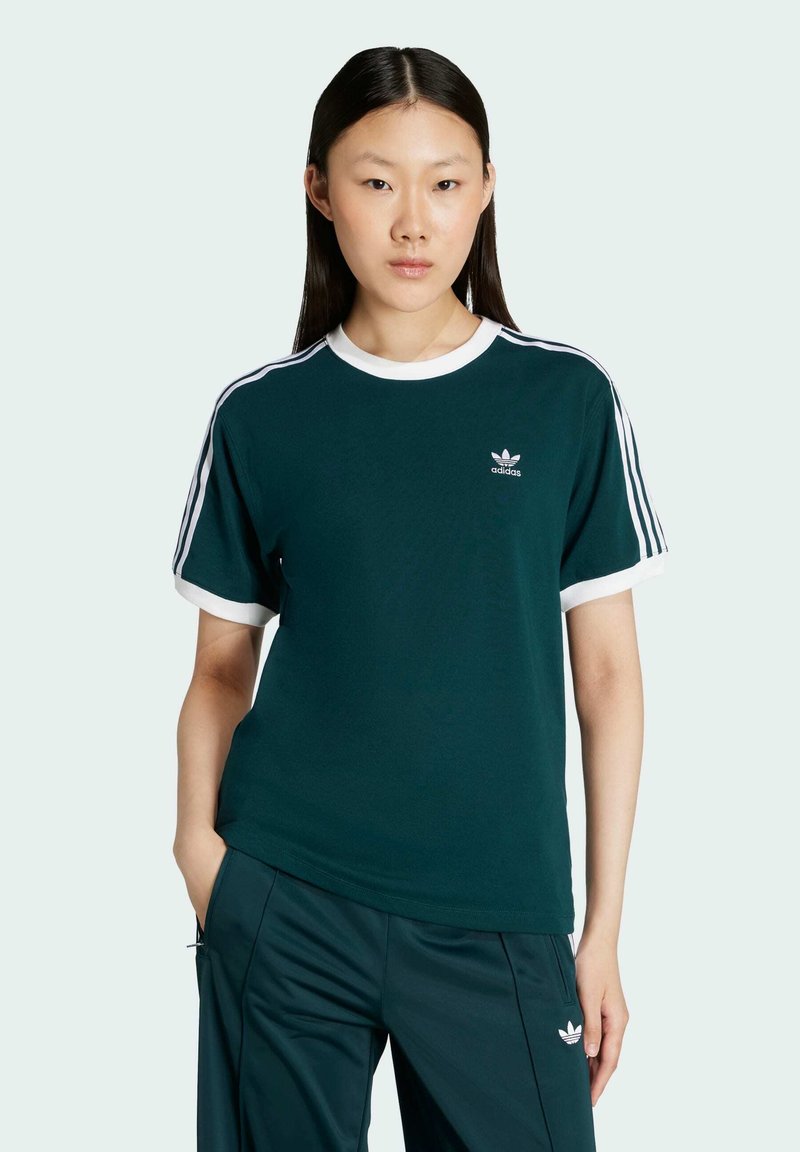 Green short-sleeve t-shirt with white collar and cuffs, featuring three white stripes on shoulders and a small Adidas logo on chest.