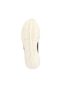Semelle de chaussure avec une surface en caoutchouc blanc texturé, présentant un motif en zigzag pour l'adhérence et une section rectangulaire près du talon.
