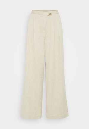 Bredde benbukser laget av beige lin, med frontknapp, legg og en jevn tekstur.