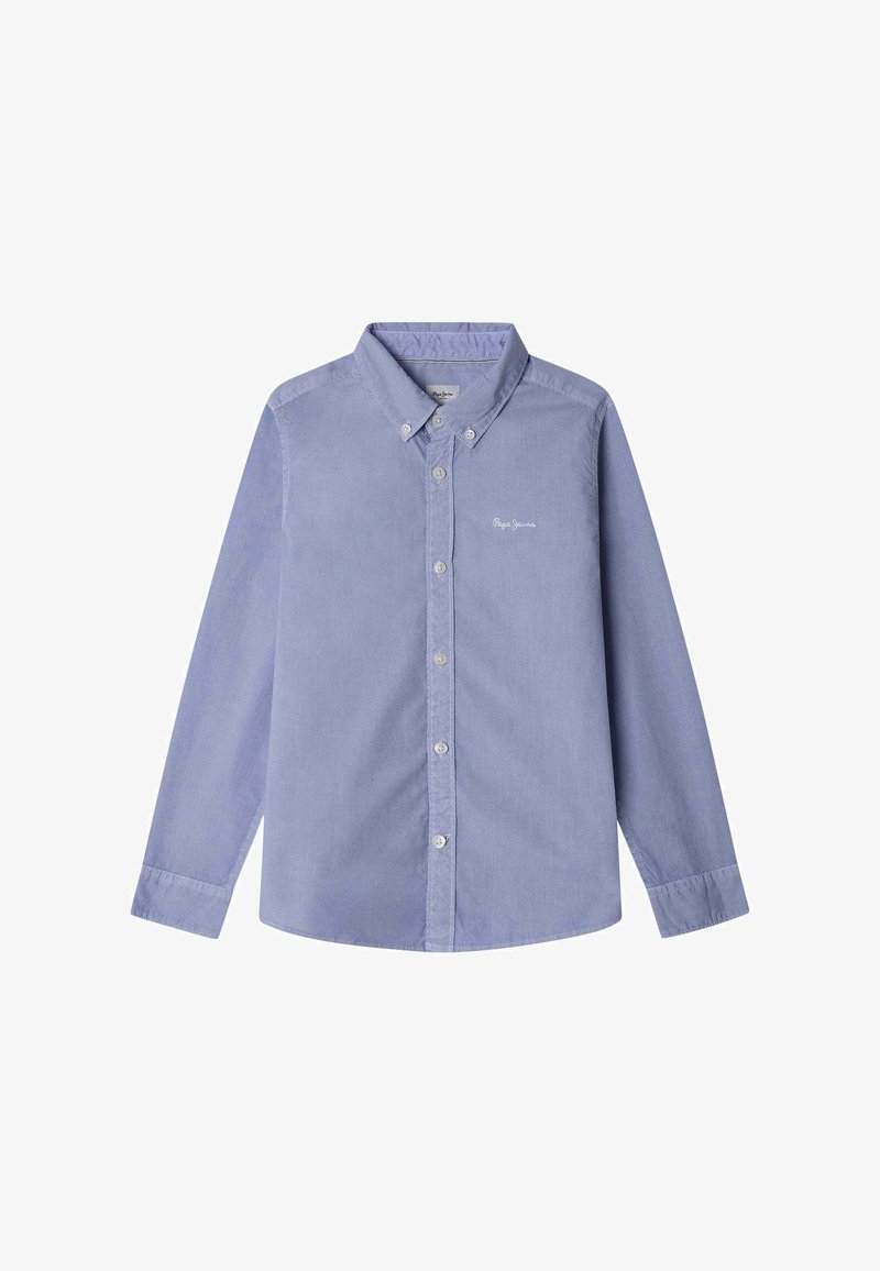 Gaiši zils krekliņš no kokvilnas auduma. Tam ir norādīta apkakle, garas piedurknes un smalks logo izšuvums krūšu apvidū.