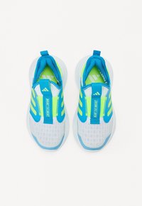 Children’s athletic shoes, featuring a white mesh upper with blue and neon green accents, elastic straps, cushioned sole, and a looped pull tab.