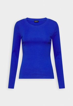 Haut en tricot côtelé à manches longues, bleu cobalt vif, avec un col rond et une silhouette ajustée.