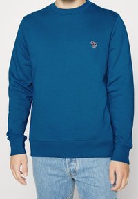 Blauwe crewneck sweatshirt van glad katoen, met lange mouwen en een klein geborduurd paardenlogo op de borst.