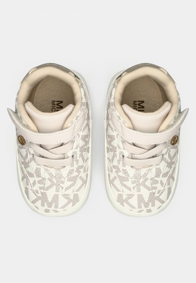 White sneakers with a textured pattern featuring geometric shapes. Soft fabric upper, contrast stitching, and lightweight rubber soles.