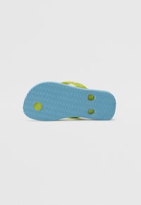 Green flip-flop with a blue textured sole. The sole has a ribbed pattern and circular detailing, designed for grip and comfort.