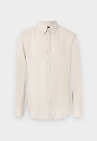 Chemise beige à manches longues avec col et boutons, présentée sur un fond clair uni.