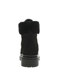 Bottes en suede noir avec un col en fausse fourrure, présentant une semelle épaisse et des détails de couture. La vue arrière met en avant la texture douce et la forme.