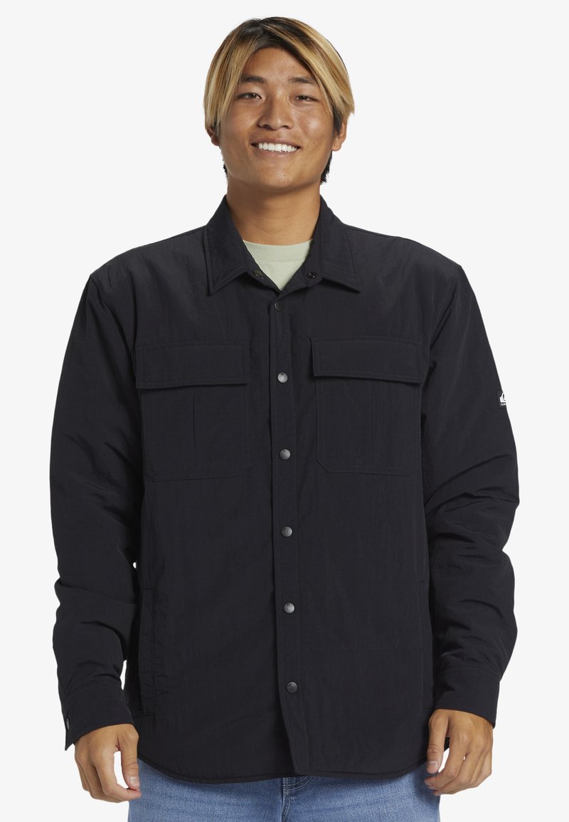 Schwarze Button-up-Hemd mit zwei Fronttaschen, aus strukturiertem Stoff, mit klassischem Kragen und Druckknöpfen.