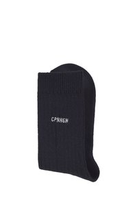 Navy blue knitted sock with ribbed cuff and white embroidered text "CPNHGN," featuring a smooth texture and standard sock shape.