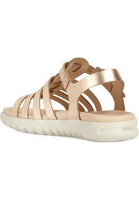 Jasnobeżowe skórzane sandały z wieloma krzyżującymi się paskami, z wyściełaną podeszwą i teksturowaną białą gumową bazą. Posiadają regulowane zapięcie.