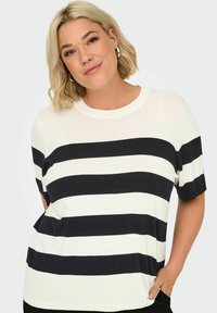 Top a maniche corte a righe, con righe orizzontali bianche e nere, scollatura rotonda e texture in maglia morbida. Maniche lunghe fino al gomito.