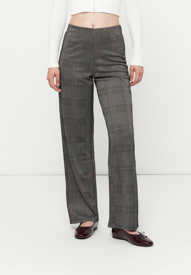 Pantalons à carreaux gris à taille haute, présentant un motif en damier noir et rouge, jambes droites et texture lisse.