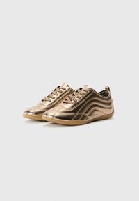 Metallic gold sneakers with a smooth texture, rounded toe, and minimalist design. Features brown laces and a rubber sole for grip.