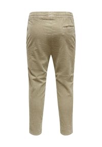 Pantaloni in corduroy beige chiaro, con un motivo a coste testurizzato, vita elastica e una tasca posteriore singola. Lunghezza fino alla caviglia su misura.
