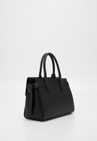 Black handbag made of smooth leather, featuring a structured shape, dual top handles, and decorative bow detail on one side.