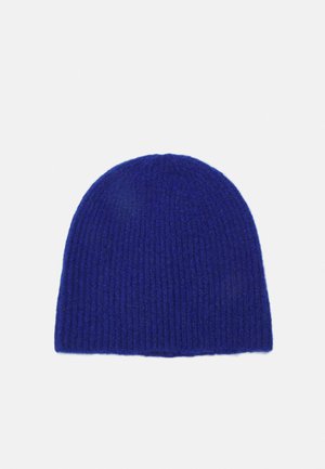 Bonnet en tricot bleu profond, avec une texture côtelée et un dessus arrondi. Fabriqué en matériau doux pour la chaleur et le confort.