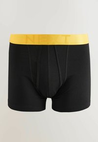 Caleçons boxer pour hommes noirs avec une large ceinture jaune portant le mot « NEXT » en lettres en relief.