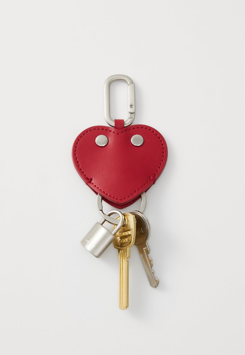 Red leather heart-shaped keychain with silver hardware, attached to metal keyring, holding keys and a silver padlock. Smooth texture.
