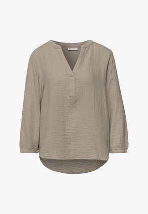 Light brown long-sleeve blouse with V-neck, textured fabric, and rounded hem, featuring a loose, relaxed fit.