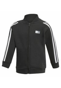 Giacca nera con zip e colletto alto, con strisce bianche lungo le maniche e un piccolo logo sul petto. Tessuto morbido.