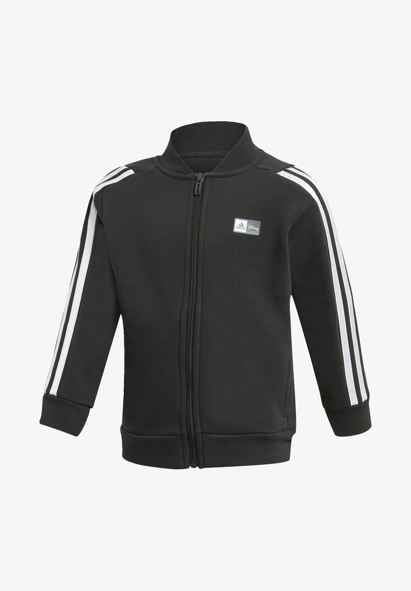 Giacca nera con zip e colletto alto, con strisce bianche lungo le maniche e un piccolo logo sul petto. Tessuto morbido.