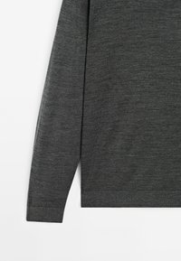 Dark gray long-sleeve top with a smooth texture, featuring a round neckline and ribbed cuffs. Simple, minimalistic design.