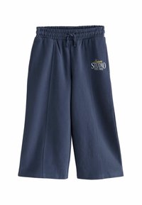 Pantalon de jogging bleu marine avec une taille élastique, un cordon de serrage et des poches latérales. Présente la broderie "Leisure Studio EST 1982" à l'avant.