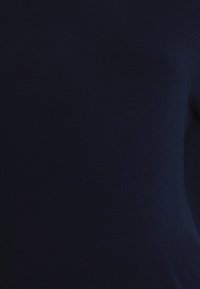 Navy blue knit fabric with a smooth texture, featuring a simple design and no visible patterns or embellishments.