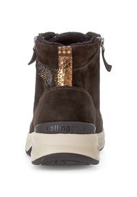 Brown suede ankle boot with a textured metallic accent, zip closure, and rubber sole. Features a logo on the heel and padded collar.