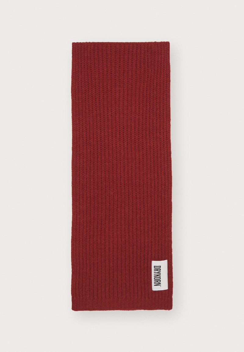 Red knitted scarf with a ribbed texture, rectangular shape, and a small white tag featuring “DRYKORN” attached to one edge.