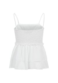 Haut blanc sans manches avec fines bretelles, corsage smocké et ajusté, et ourlet volanté à étages, présenté sur un fond blanc uni.