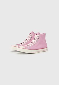 High-top sneakers in light pink suede, featuring white laces and rubber soles with a contrasting white stripe and toe cap.