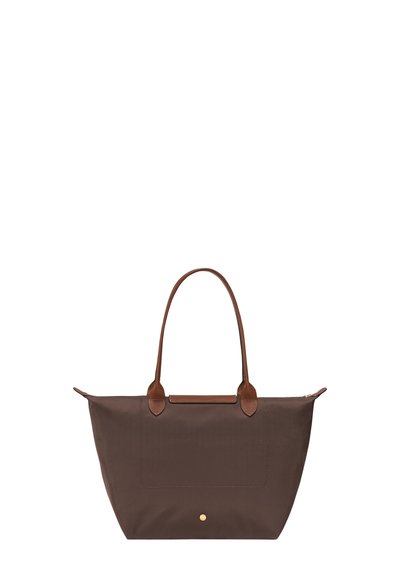 Brown tote bag with long leather handles, zip closure, and a small gold button detail on the front center.