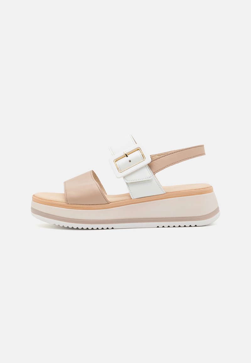 Beige and white platform sandals with a wide buckle strap, smooth leather upper, and textured outsole. Multi-toned for added detail.