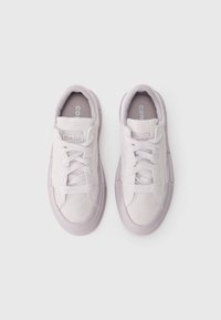 Light gray suede sneakers with lace closure, rounded toe, and rubber sole. Features "Converse All Star" branding on the tongue and side.
