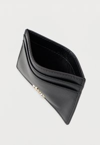 Black leather cardholder with a textured finish, featuring multiple card slots and gold-tone accents on the front. Compact and slim design.