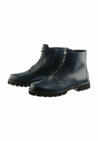 Stivali alla caviglia in pelle blu navy con una superficie liscia, dotati di chiusura con lacci e cerniera, dettagli brogue e una spessa suola in gomma nera.