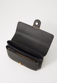 Black textured leather wallet with a gold snap closure, featuring an inner zip pocket and two open compartments.